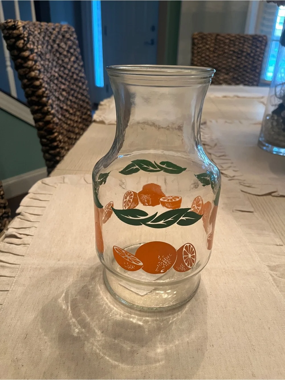 Vintage-Inspired Orange Glass Pitcher with Green Leaf Motif